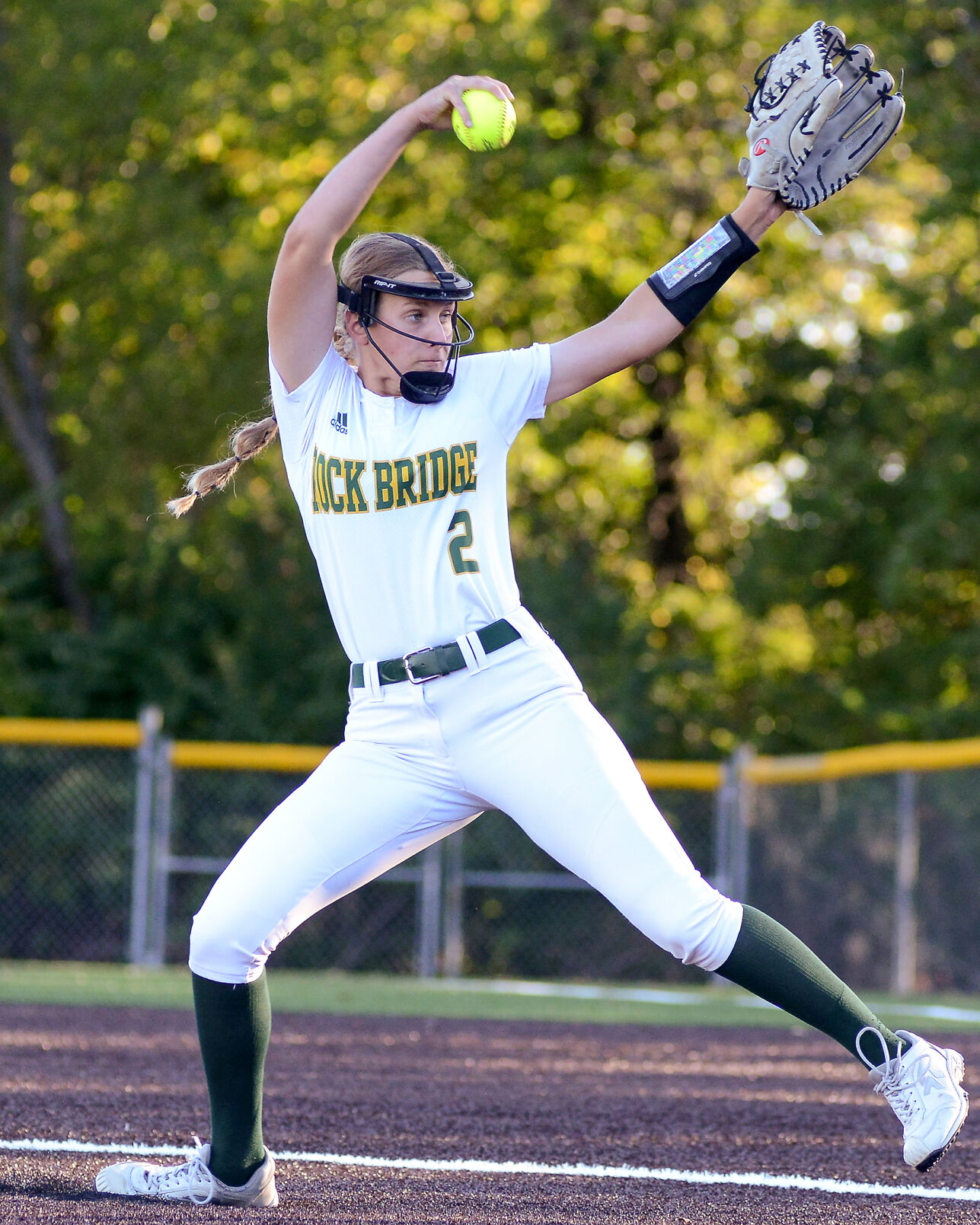 Rock Bridge pitcher Anna Christ winds her arm to release the ball toward a Hickman batter